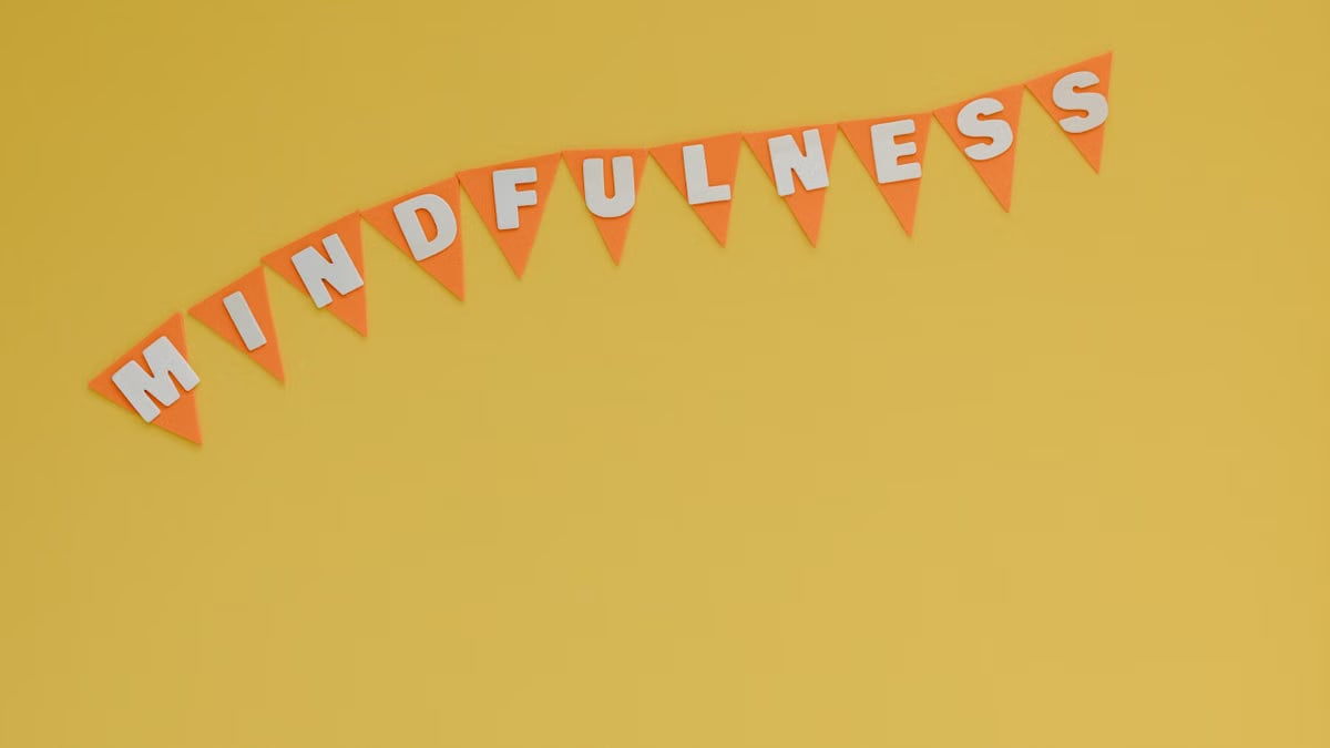 Banner with 'Mindfulness' on a bright yellow background, symbolizing calm and focus.